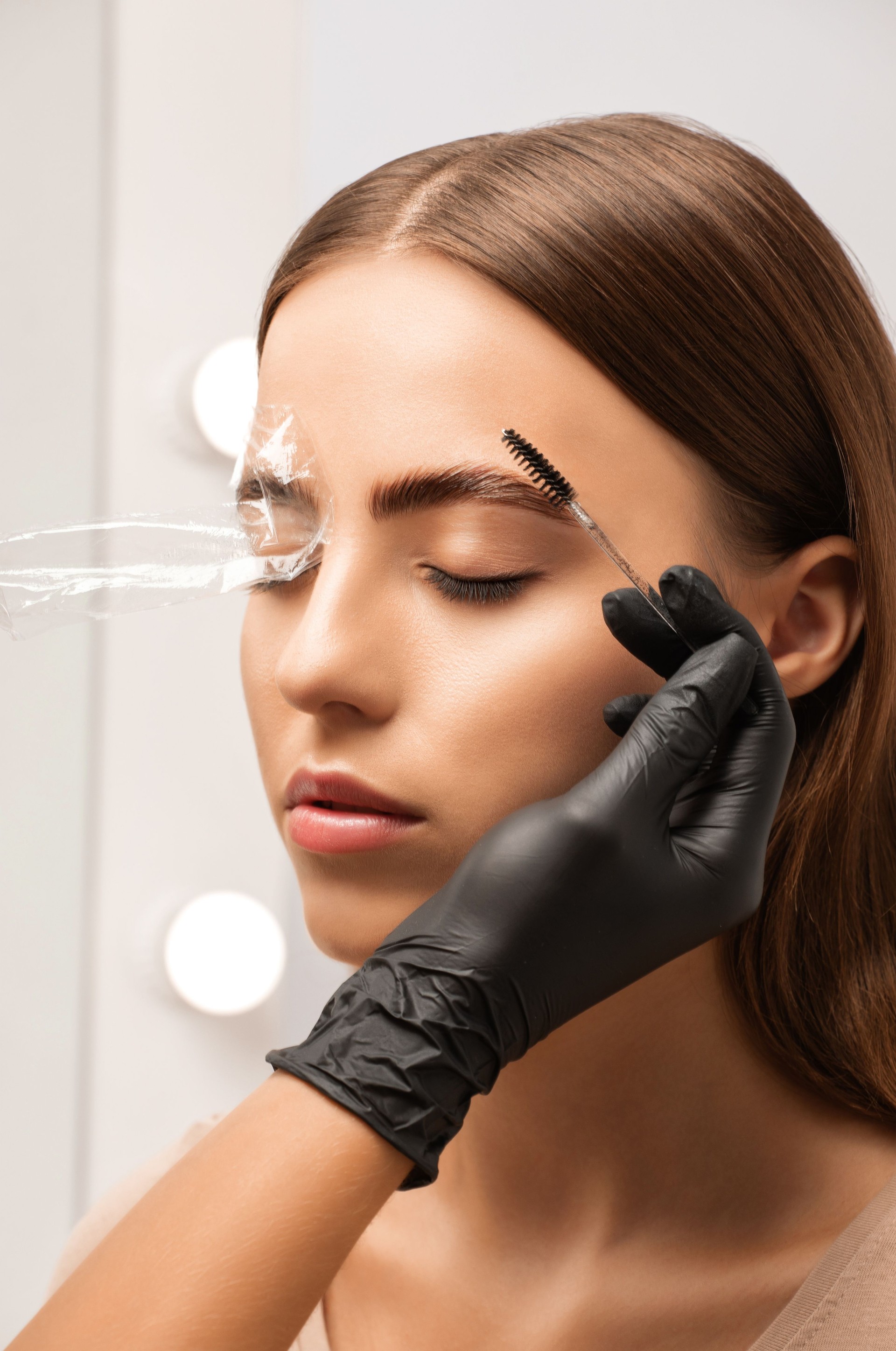 The make-up artist does Long-lasting styling of the eyebrows and will color the eyebrows. Eyebrow lamination. Professional make-up and face care.